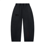 Villain Disruptor unisex mineral-wash barrel-leg pants by Wolvyn Apparel in charcoal with red Villain lettering.