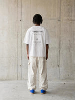 Tshirt by Wolvyn Apparel; white oversized boxy tee with black Foundations print on back