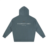 Oversized blue-gray fleece hoodie, back view with FOUNDATIONS SERIES 002 graphic and Area 480 badge, Wolvyn Apparel.
