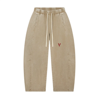 Pants: Villain Disruptor mineral-wash barrel-leg pants in tan with white drawstrings and red V logo.