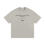 T-shirt by Wolvyn Apparel, front view, light gray cotton with black slogan Some brands follow culture. We build it.