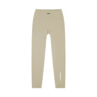 Wolvyn Apparel Standard Issue high-waisted yoga leggings in beige; flat-lay with white STANDARD ISSUE text along the outer leg.