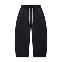 Unisex mineral-wash barrel-leg pants in black with white drawstrings and red V logo