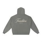 Grey fleece hoodie back view with cream Foundations Script and Wolvyn Apparel branding, Series 002.