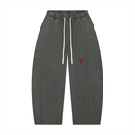 Unisex pants: Villain by Wolvyn Disruptor mineral-wash barrel-leg in gray with white drawstrings and red V logo.