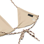 Beige recycled string bikini top with patterned ties and subtle brand tag detail