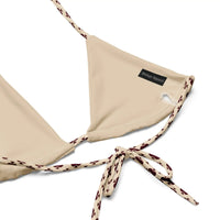 Beige recycled string bikini top with patterned ties and subtle brand tag detail
