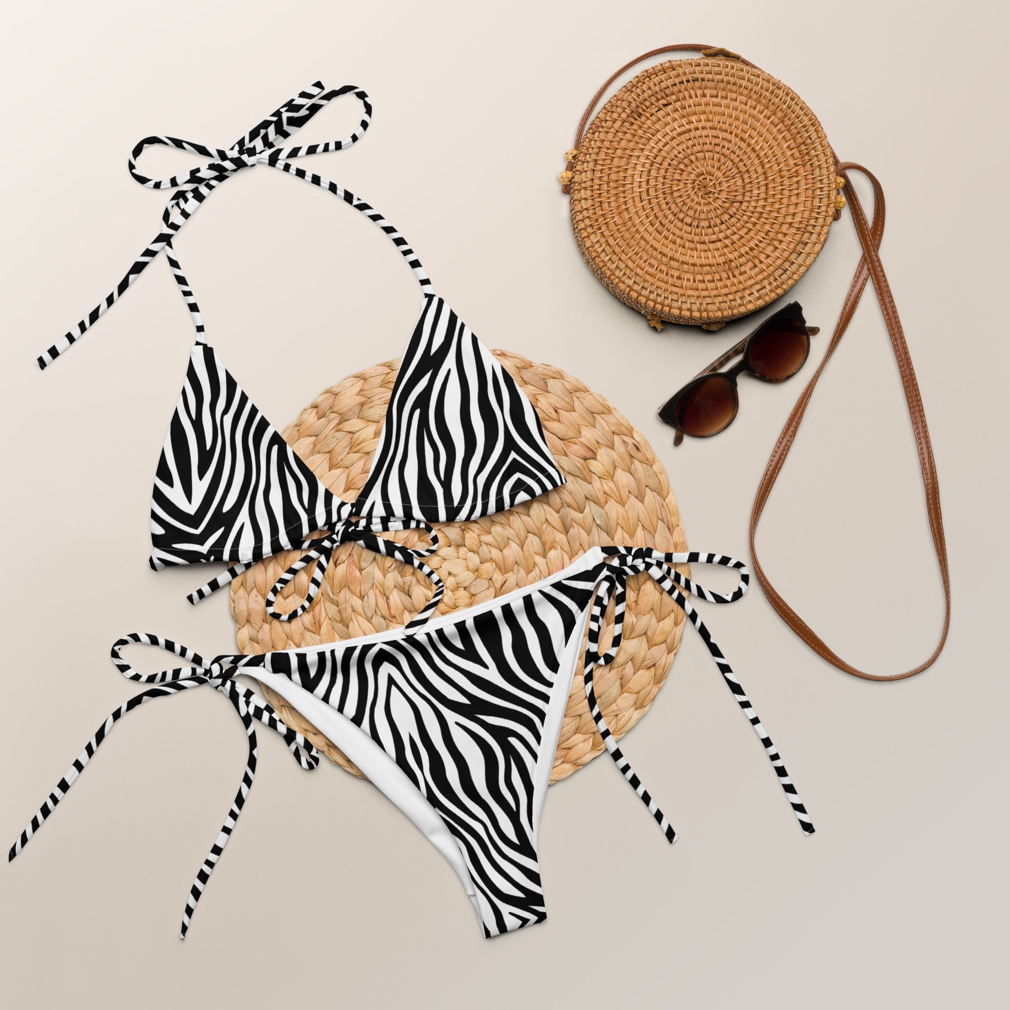 Zebra print string bikini set with tie sides, styled with round rattan bag and sunglasses