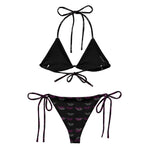 Black string bikini set with tie sides, logo print bottoms, and triangle top on white background