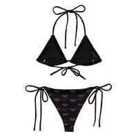 Black string bikini set with tie sides, logo print bottoms, and triangle top on white background