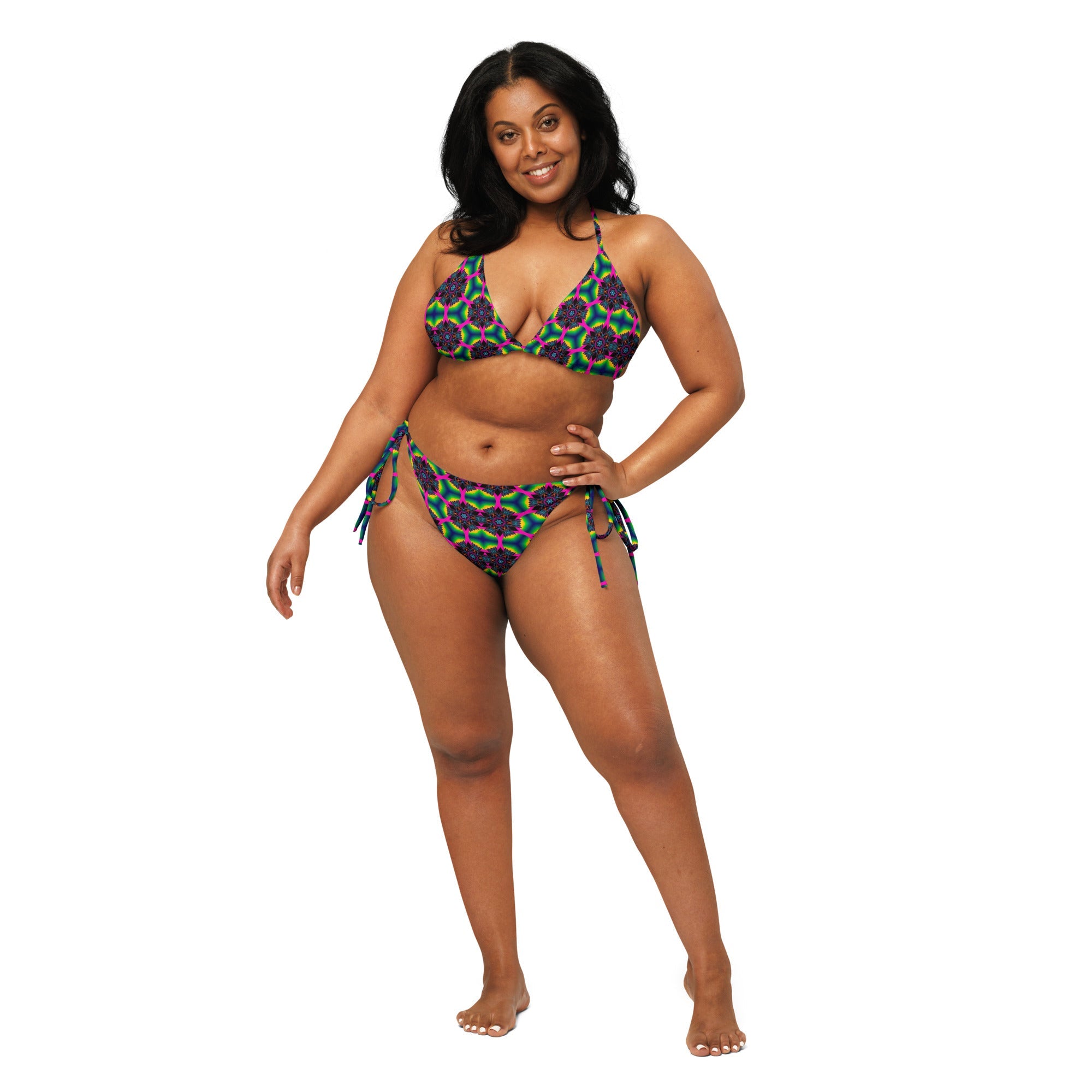 Woman modeling colorful geometric print string bikini with adjustable side ties on white background