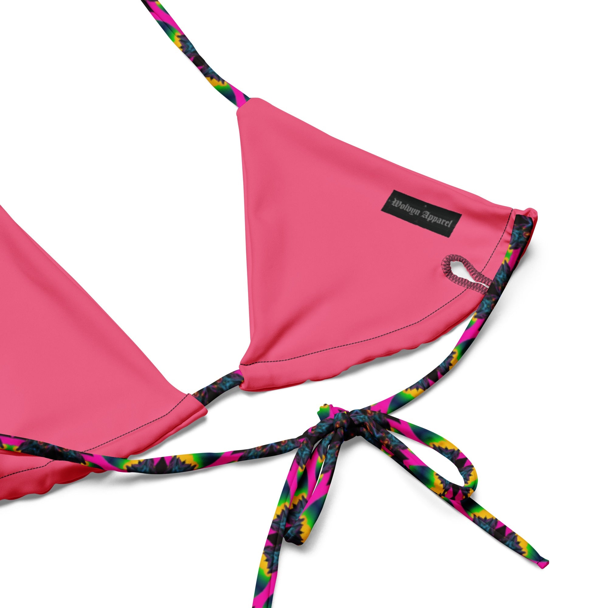 Pink string bikini top with colorful patterned straps and label, flat lay.