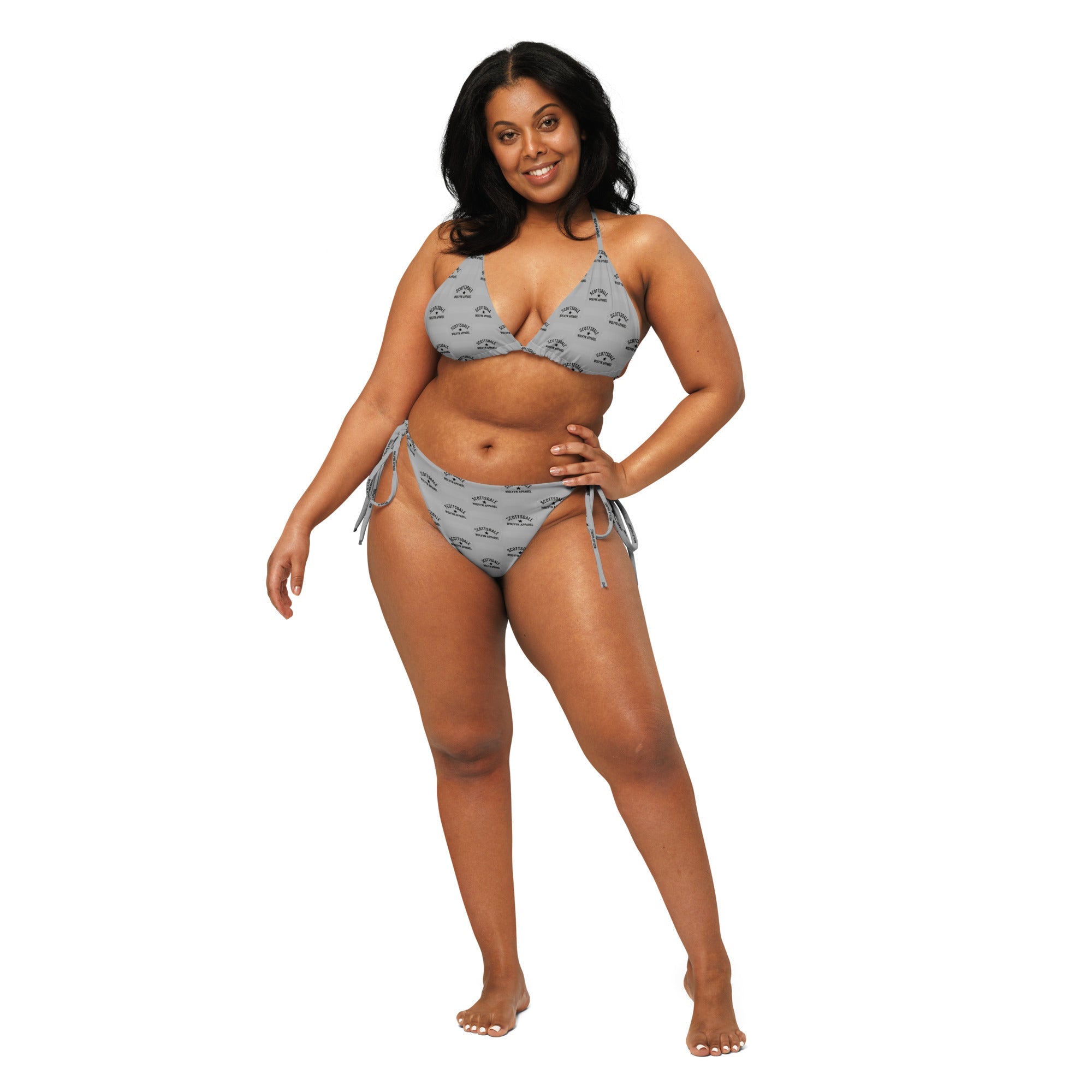 Woman in a gray recycled string bikini with all-over print and tie-side bottoms