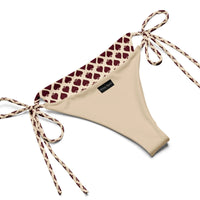 Beige string bikini bottom with maroon heart pattern and adjustable side ties