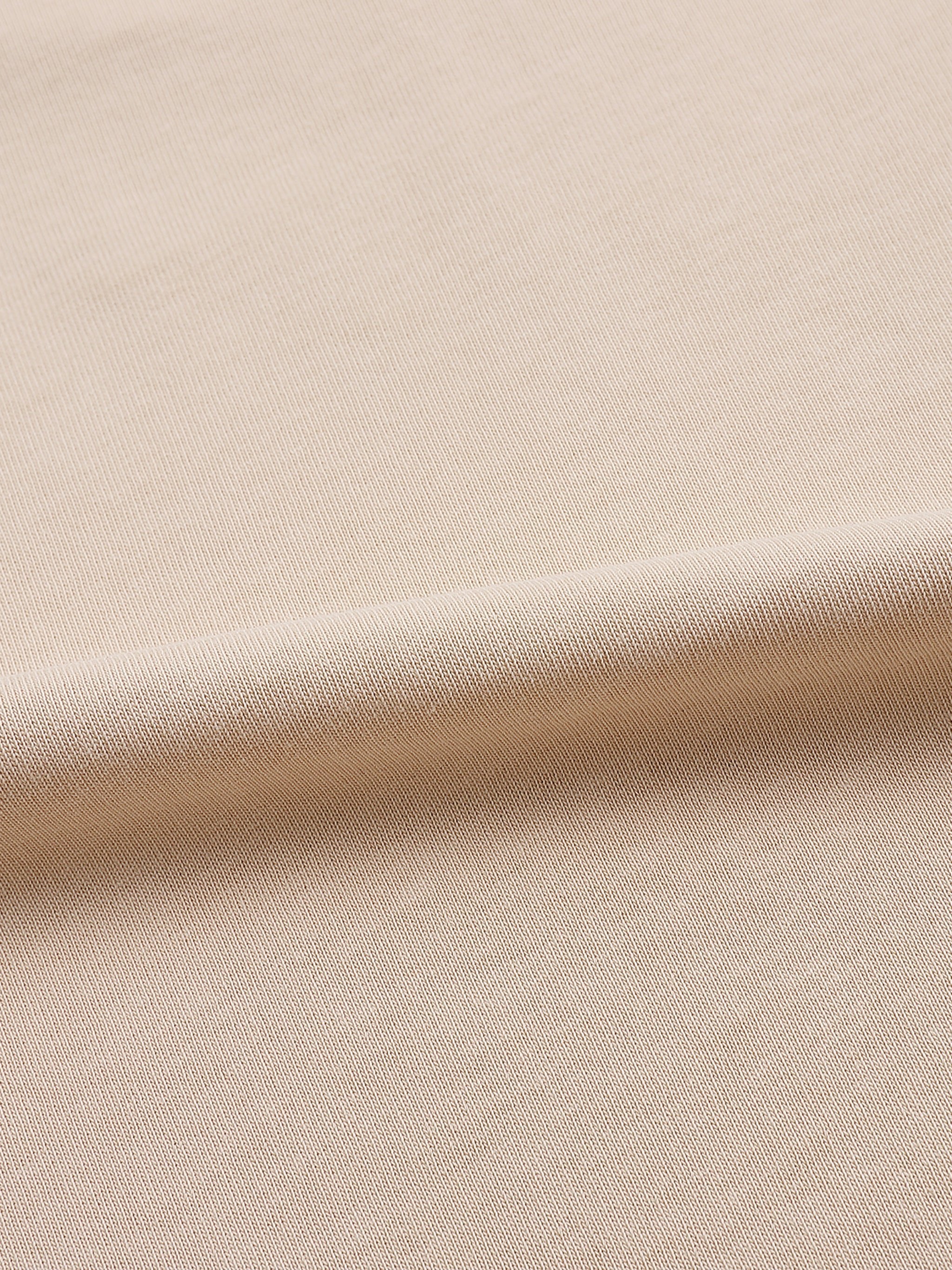 Close-up of beige heavyweight cotton t-shirt fabric with textured weave
