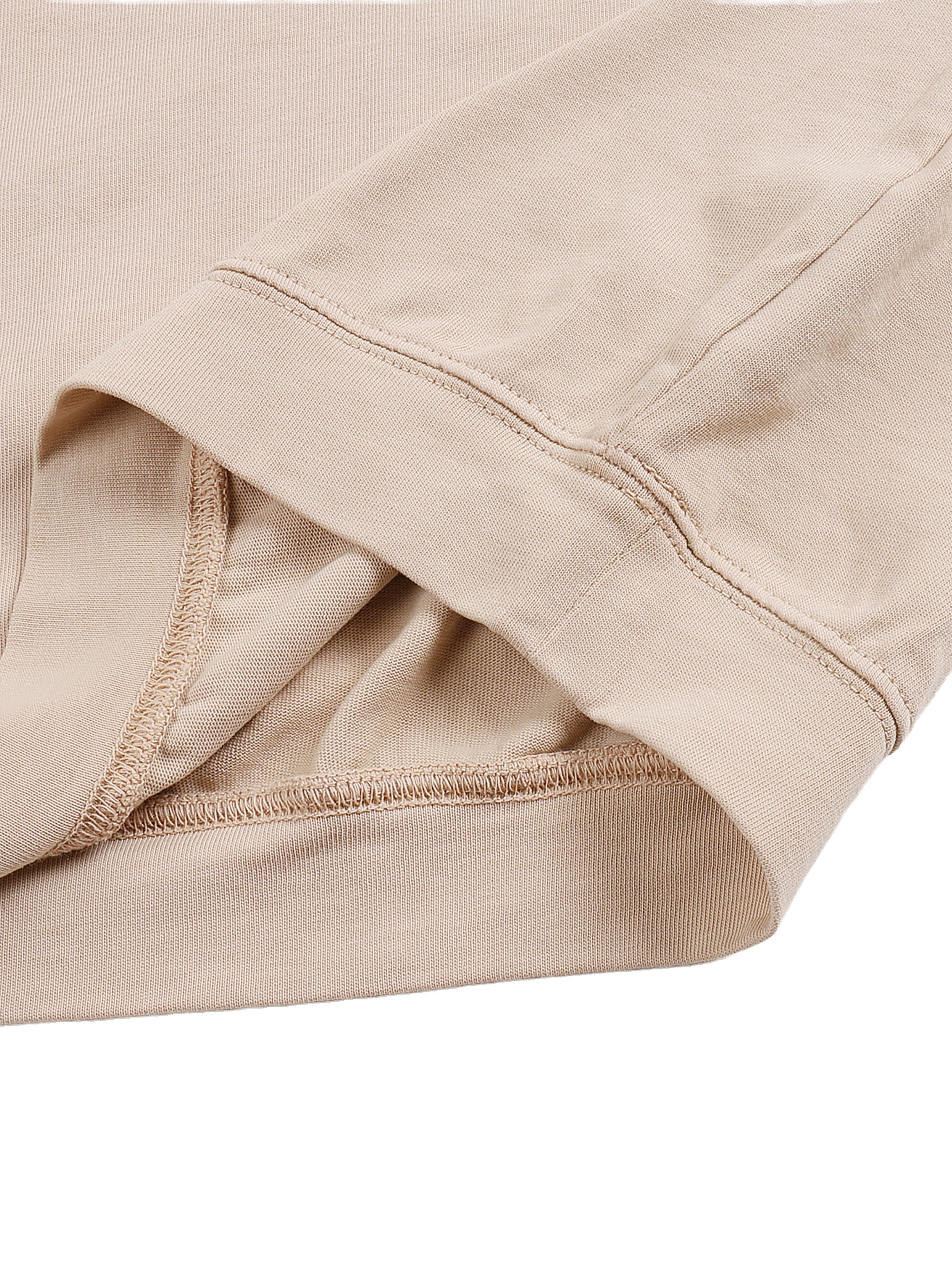 Close-up of beige cotton T-shirt with asymmetric shoulder and oversized sleeve detail