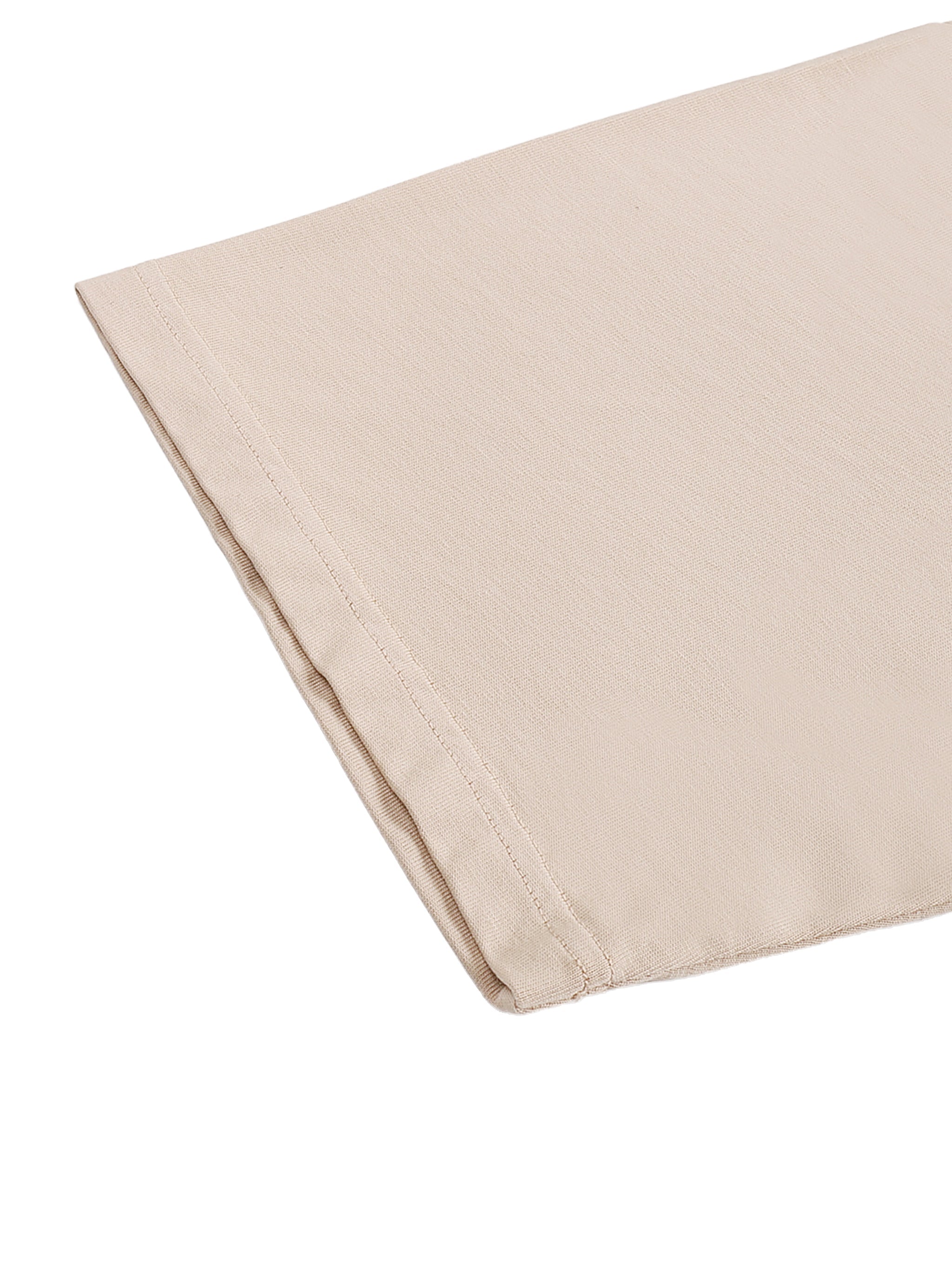 Close-up of beige asymmetric shoulder oversized cotton T-shirt fabric and stitching detail