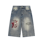 Wolvyn Apparel vintage wash baggy denim shorts with red paint-splatter and black graphics