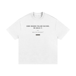 White cotton T-shirt flat lay with black slogan Some brands follow culture. We build it. Wolvyn Apparel.