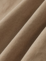 Close-up of khaki cotton twill fabric, showing durable, elastic texture for cargo pants