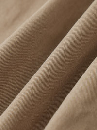 Close-up of khaki cotton twill fabric, showing durable, elastic texture for cargo pants