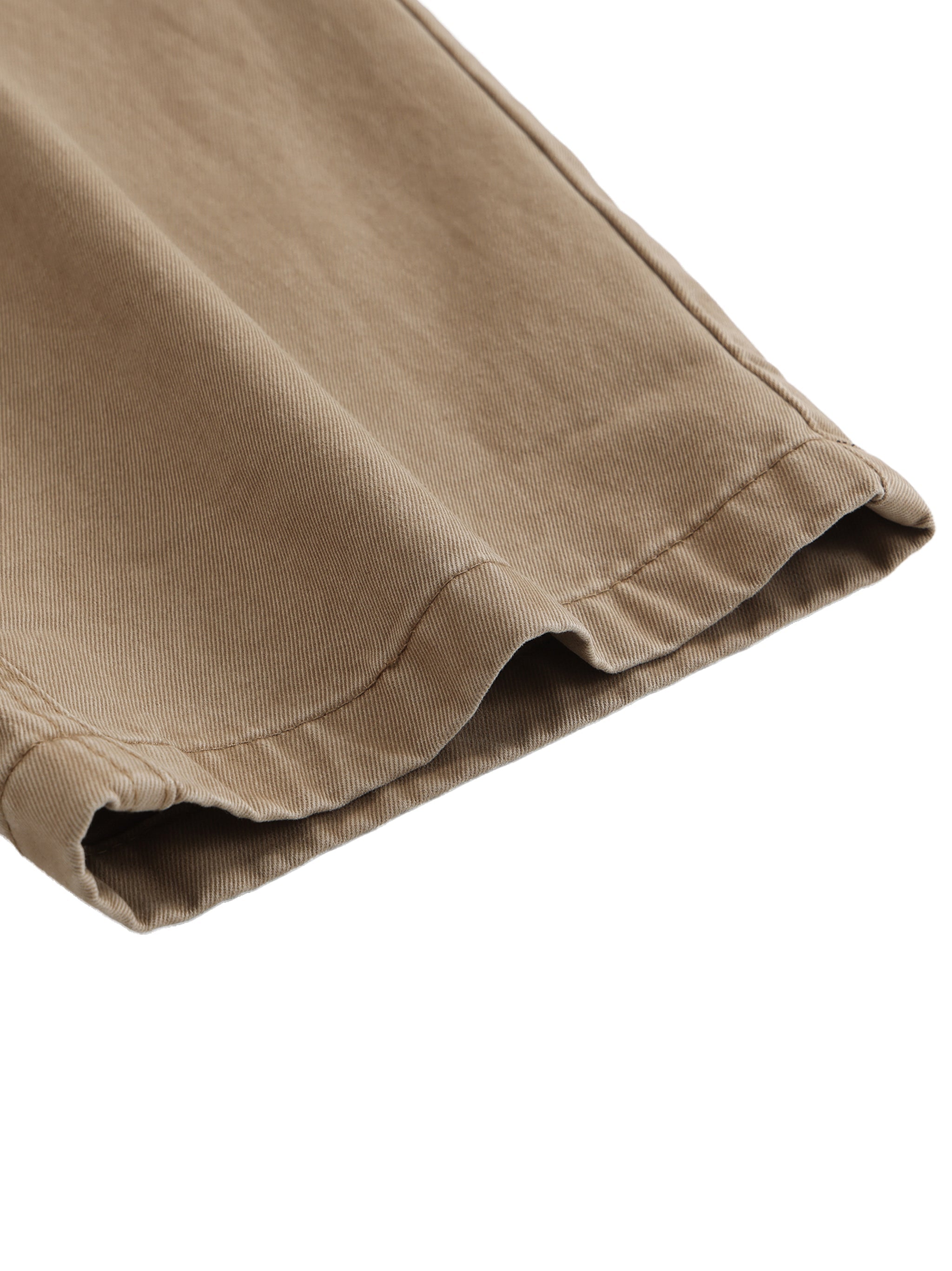 Close-up of tan cotton cargo pants hem with visible stitching, heavyweight streetwear fabric