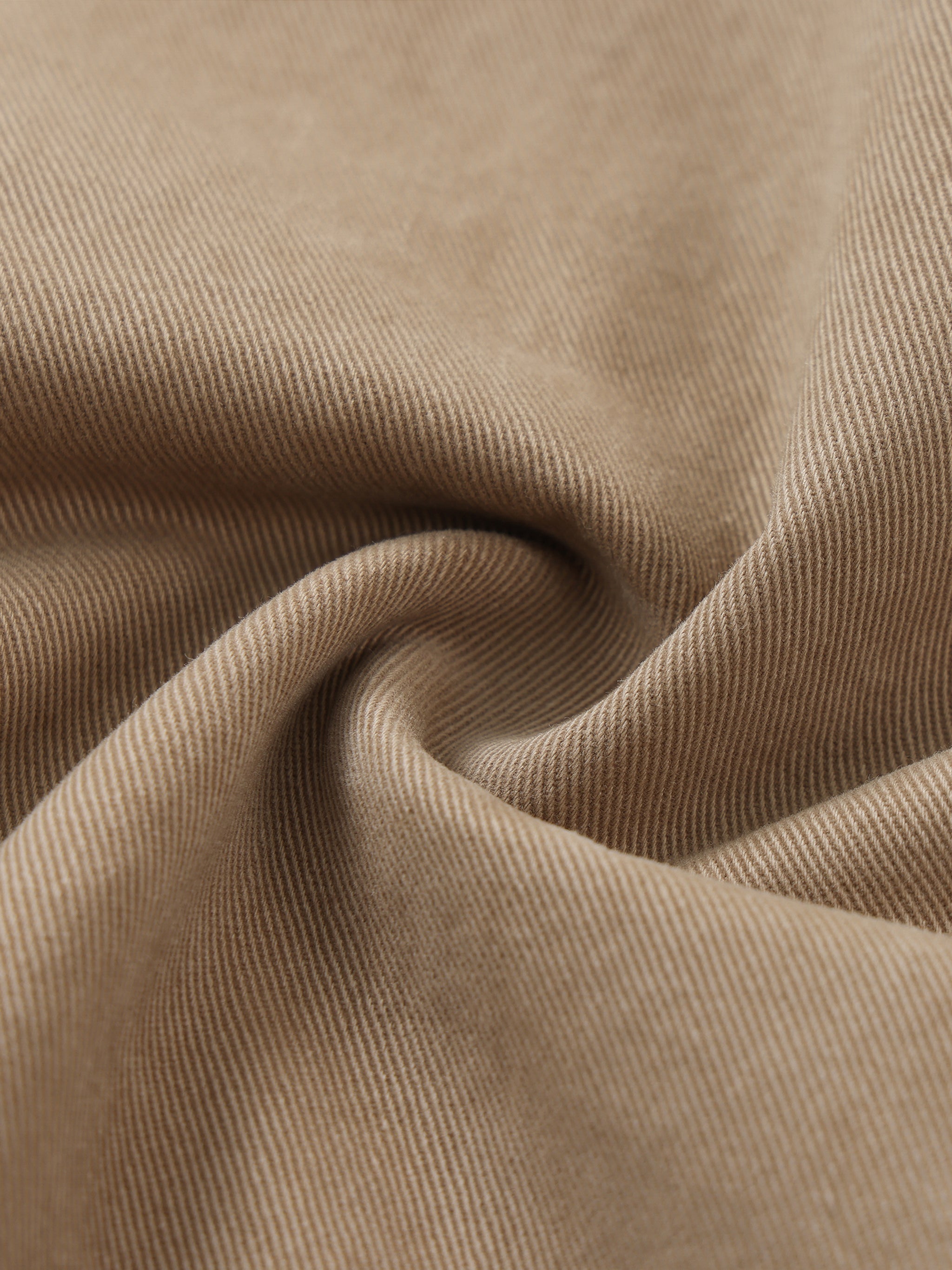 Close-up of beige cotton elastic waist cargo pants fabric, showcasing texture and weave