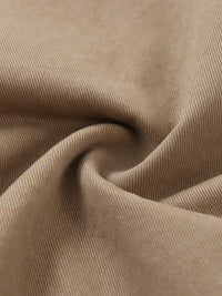Close-up of beige cotton elastic waist cargo pants fabric, showcasing texture and weave