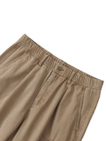 Beige cotton cargo pants with elastic waist and button closure, front pocket detail