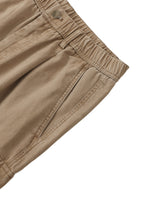 Close-up of khaki cotton cargo pants with elastic waistband and side pocket