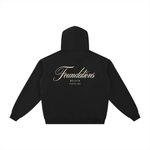 Hoodie, black fleece zip-through, back view with cream Foundations script logo; Wolvyn Apparel, Foundations collection.