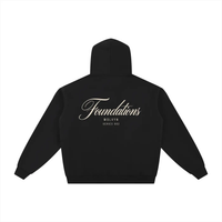 Hoodie, black fleece zip-through, back view with cream Foundations script logo; Wolvyn Apparel, Foundations collection.