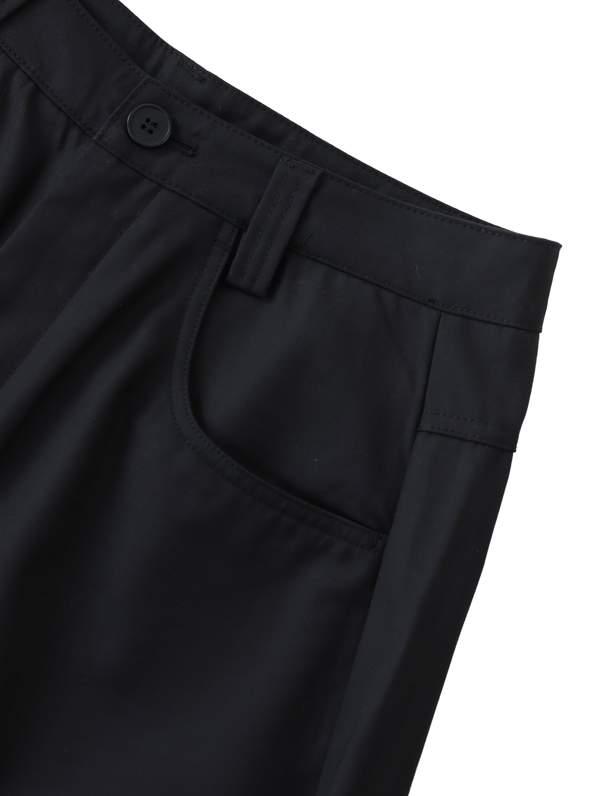 Close-up of black barrel dress pants with button waist, front pocket, and belt loop details