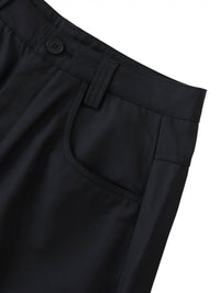 Close-up of black barrel dress pants with button waist, front pocket, and belt loop details