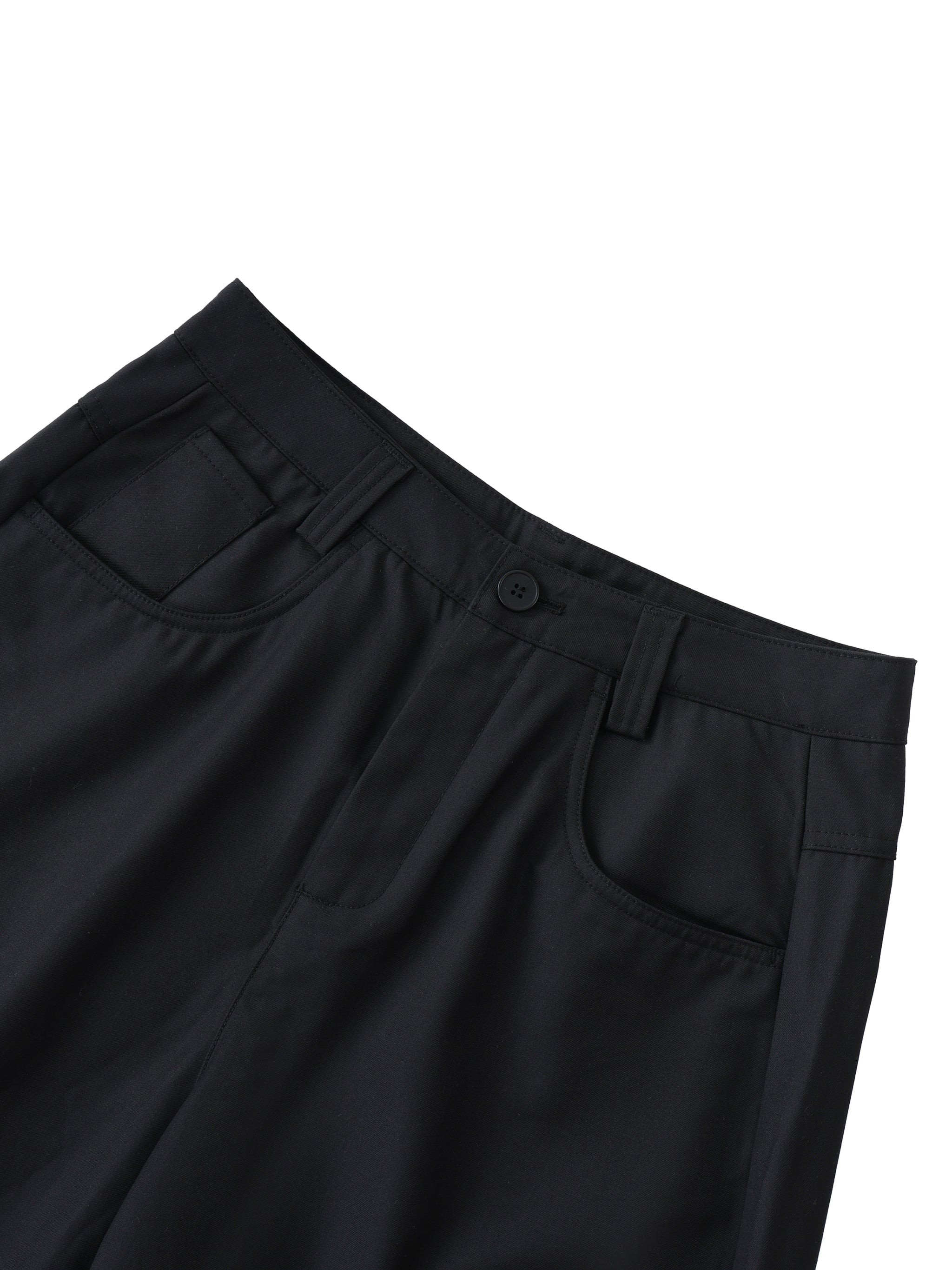 Close-up of black barrel dress pants with front pockets and belt loops on white background