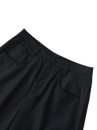 Close-up of black barrel dress pants with front pockets and belt loops on white background