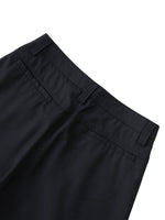 Close-up of black dress pants with belt loops and back pockets on white background