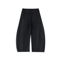 Black barrel-leg dress pants with wide silhouette, back pockets, and belt loops