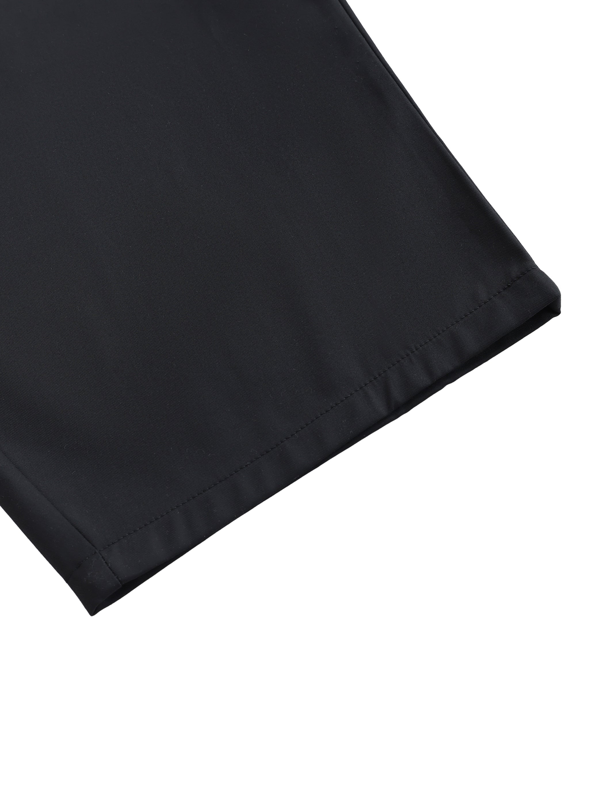 Close-up of black barrel dress pants hem on white background