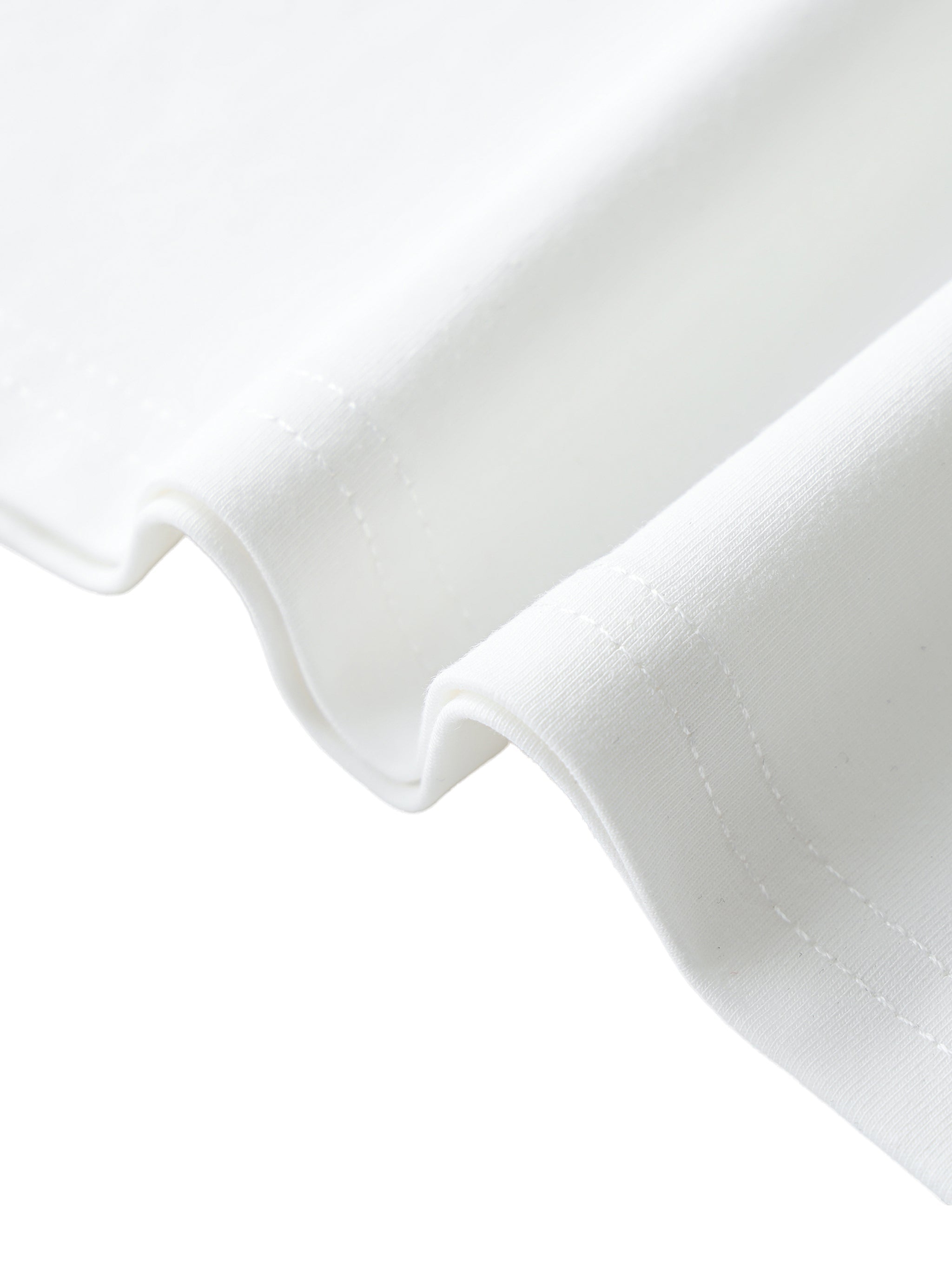 Close-up of white ribbed t-shirt hem with visible stitching and soft fabric texture