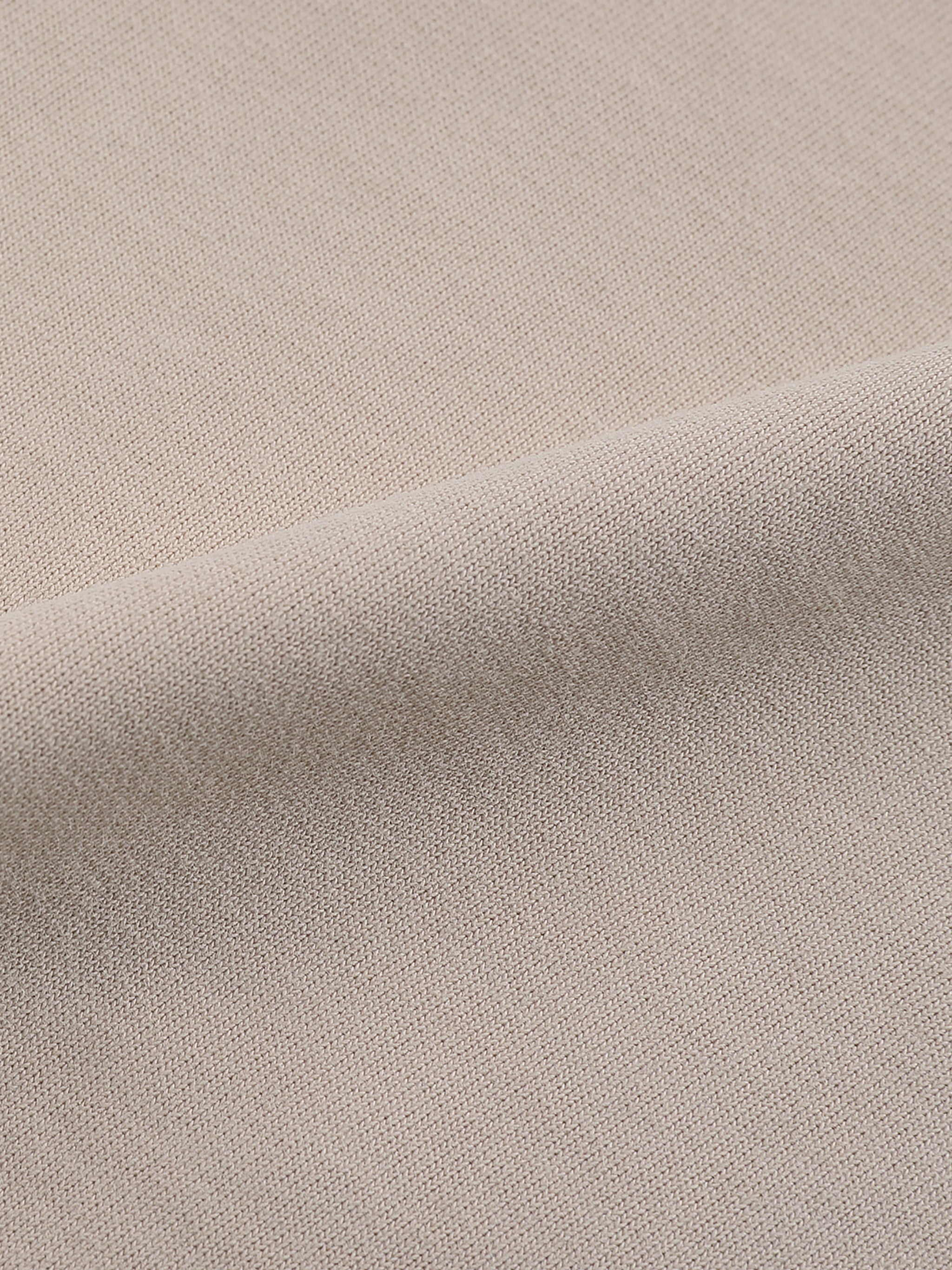 Close-up of heavyweight beige cotton fabric texture for streetwear shorts