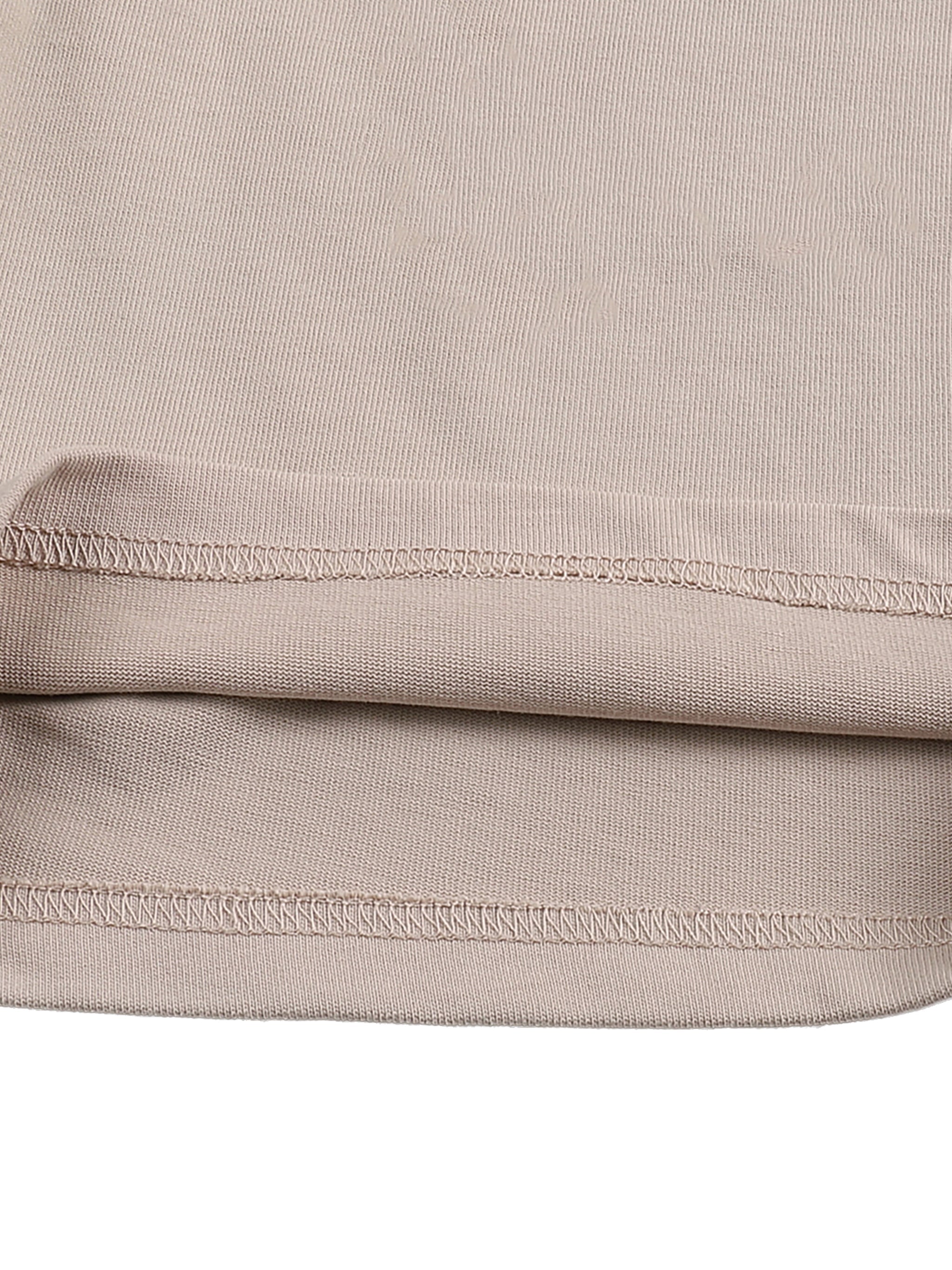 Close-up of beige heavyweight cotton shorts hem with visible stitching detail