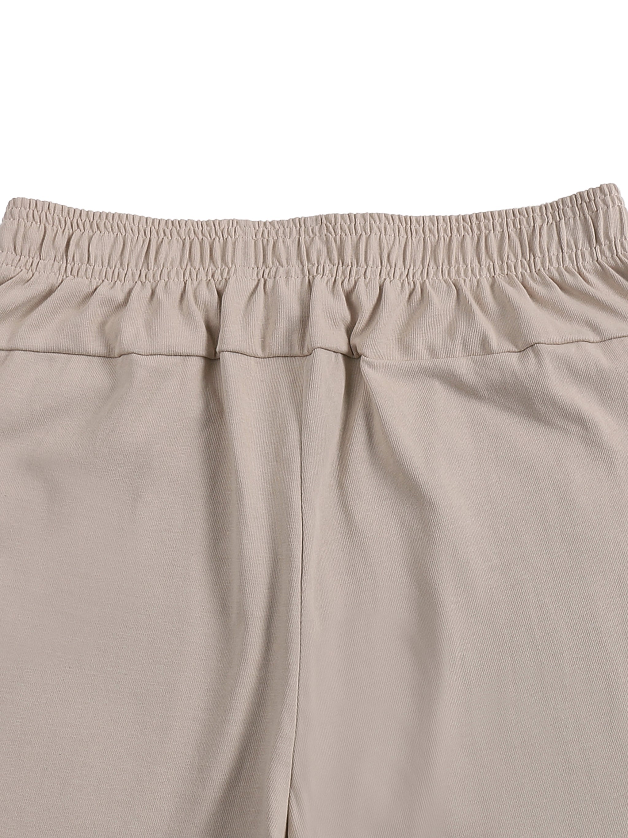 Beige heavyweight cotton shorts with elastic waistband, close-up of back detail