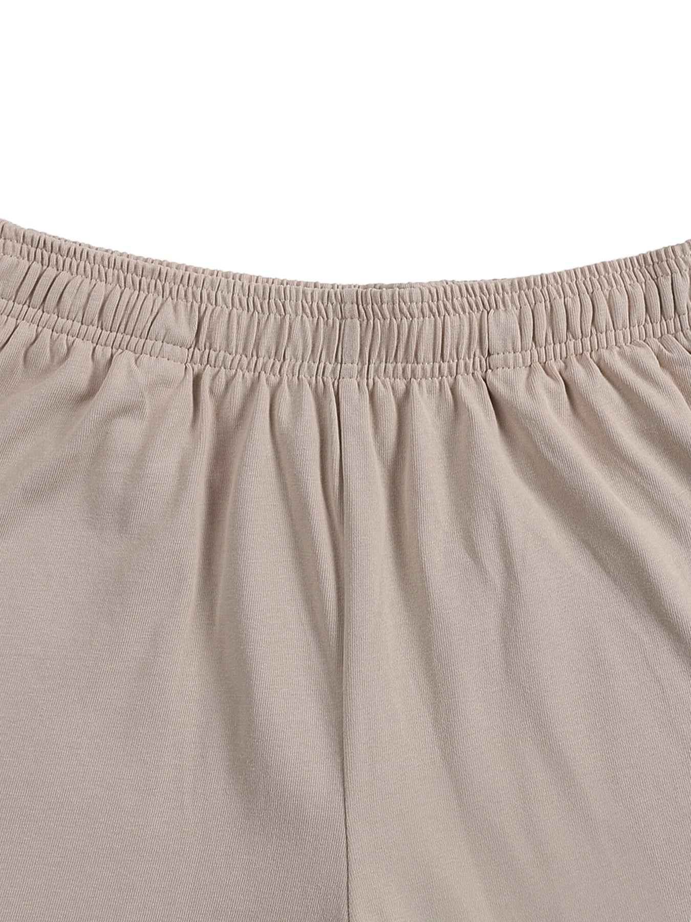 Close-up of beige heavyweight cotton shorts with elastic waistband, streetwear style