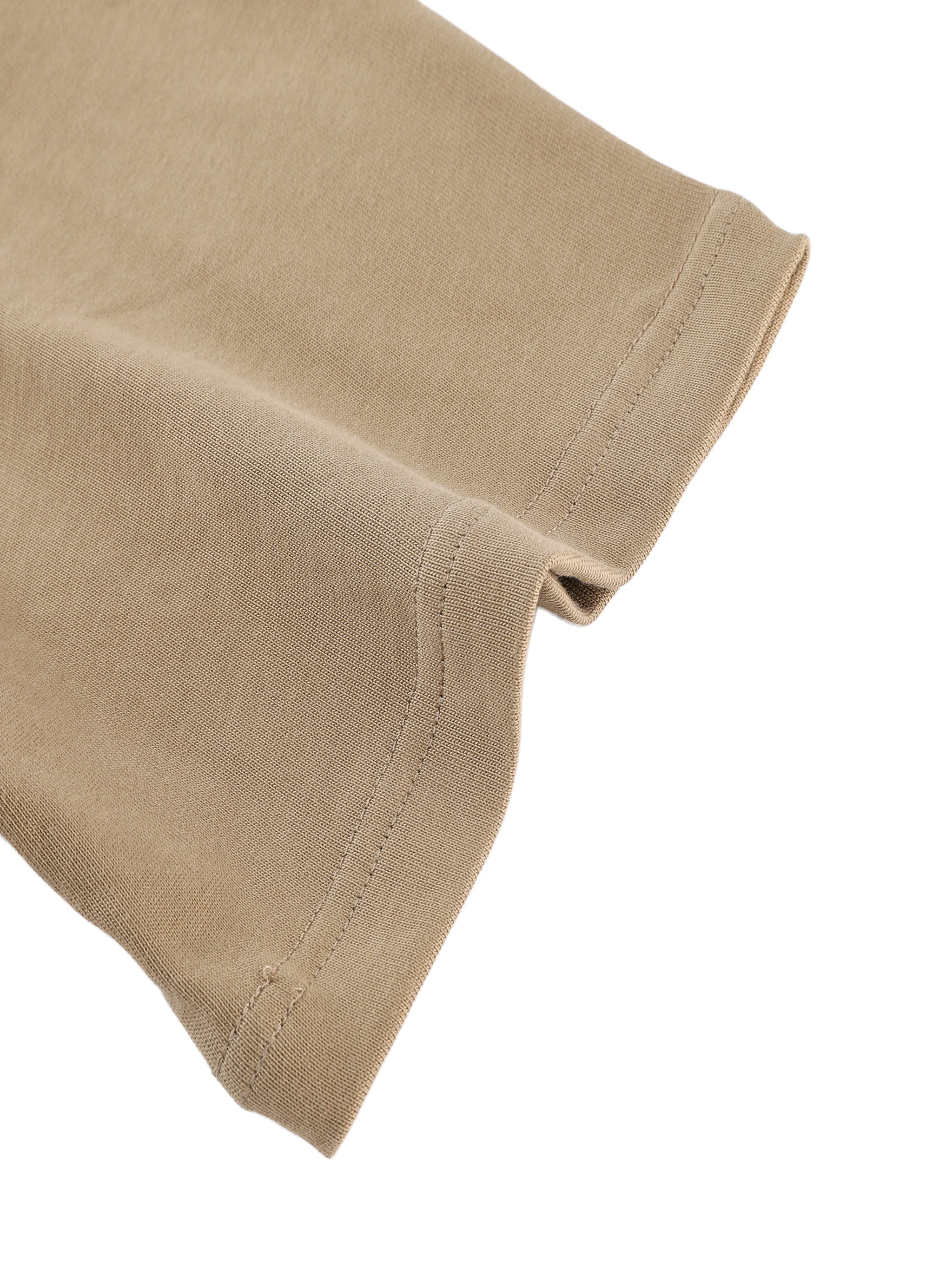 Close-up of heavyweight cotton t-shirt sleeve in beige color, flat lay on white background