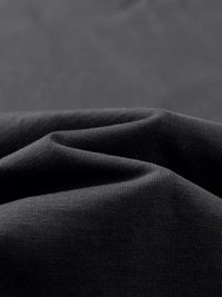 Tshirt by ODMPOD Wolvyn Apparel Elevated 305 GSM Earth Tone, close-up of dark woven fabric.