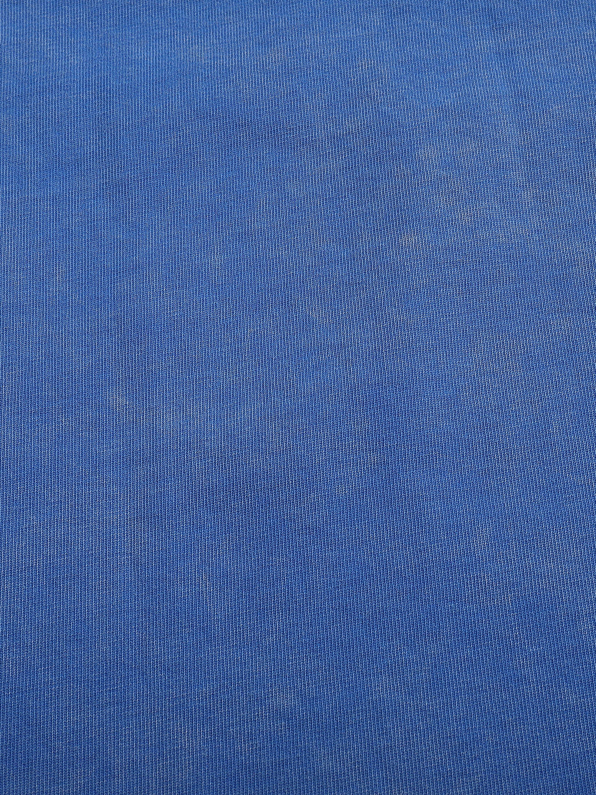 Close-up of blue heavyweight knit fabric, showcasing texture and fine ribbed pattern.