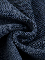 Close-up of dark blue heavyweight knit fabric showing detailed texture and weave.