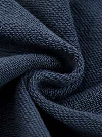 Close-up of dark blue heavyweight knit fabric showing detailed texture and weave.