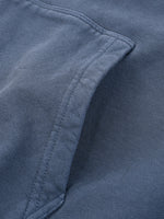 Close-up of a blue heavyweight streetwear garment pocket with textured fabric